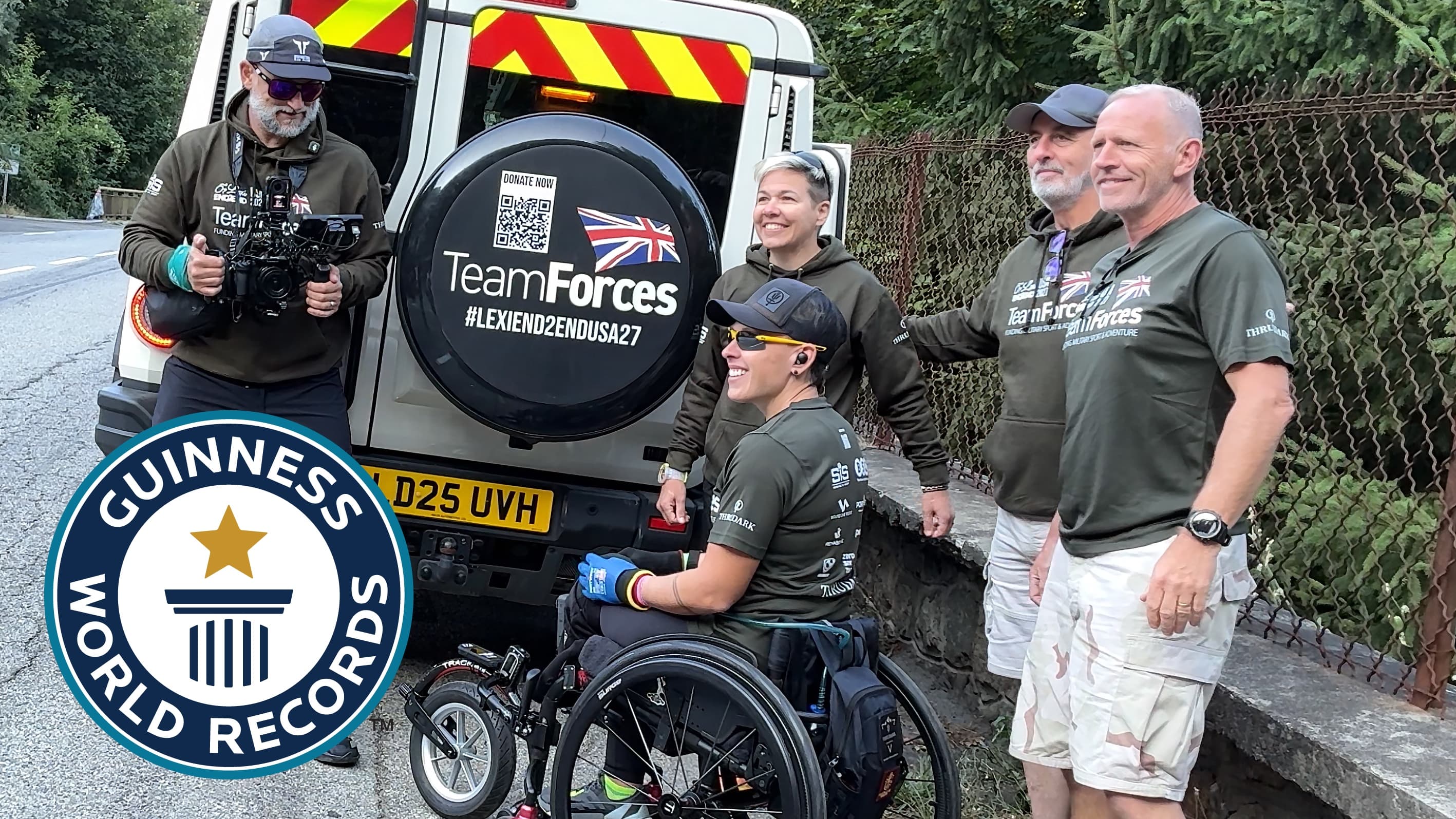 Lexi Chambers in her wheelchair with the Team Forces crew beside their support vehicle at Alpe d'Huez, with the Guinness World Records logo
